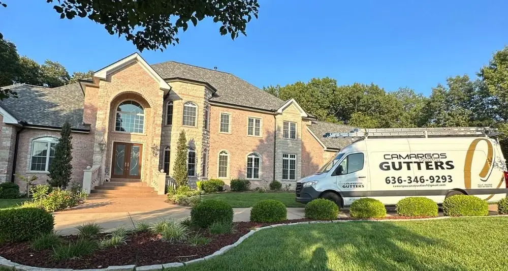 Camargos Seamless Gutters van parked at a St. Louis home with new seamless gutters